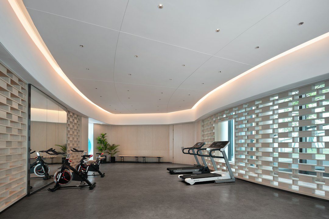 Rows of full-size treadmills in a bright indoor exercise room